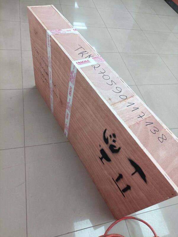 Art packed for shipping in wooden crate.