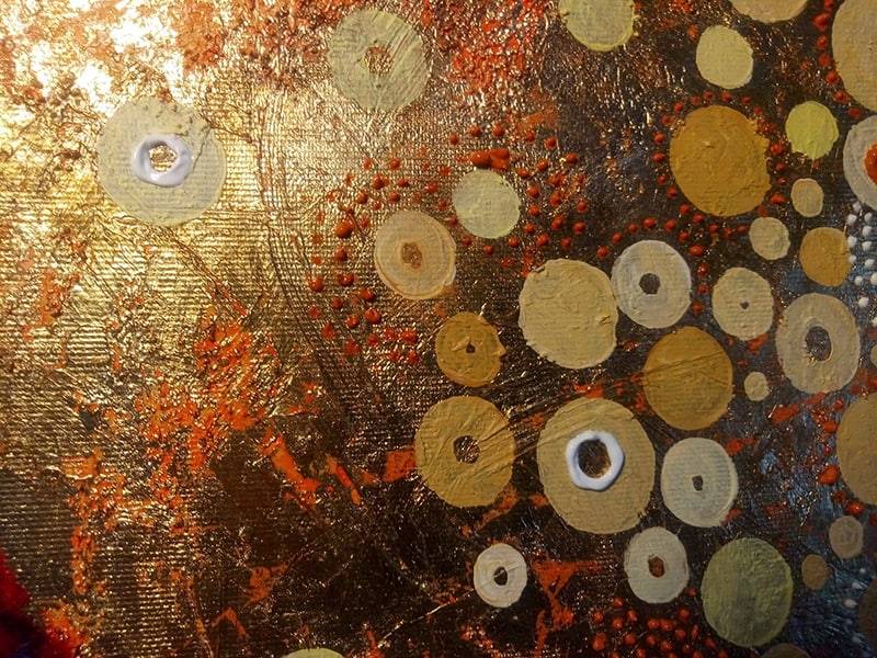 Pattern and decoration: Close-up of circular motifs on gold background, with the texture of paint and canvas highlighted. 