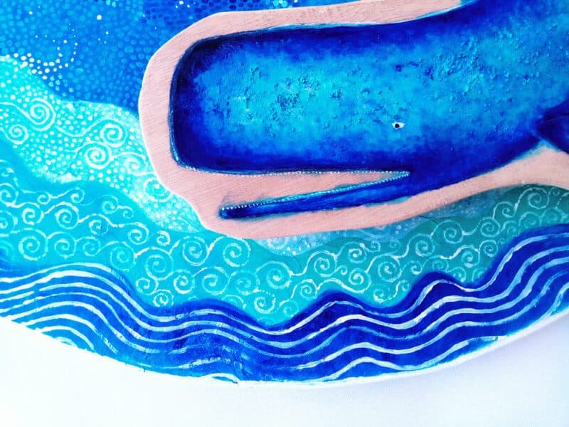 Blue whale, folk art; front of whale painted on wood, in blue.
