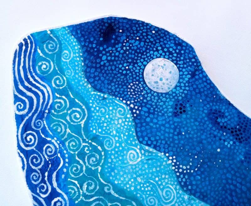 Blue whale; detail of whale art on wood, in blue.